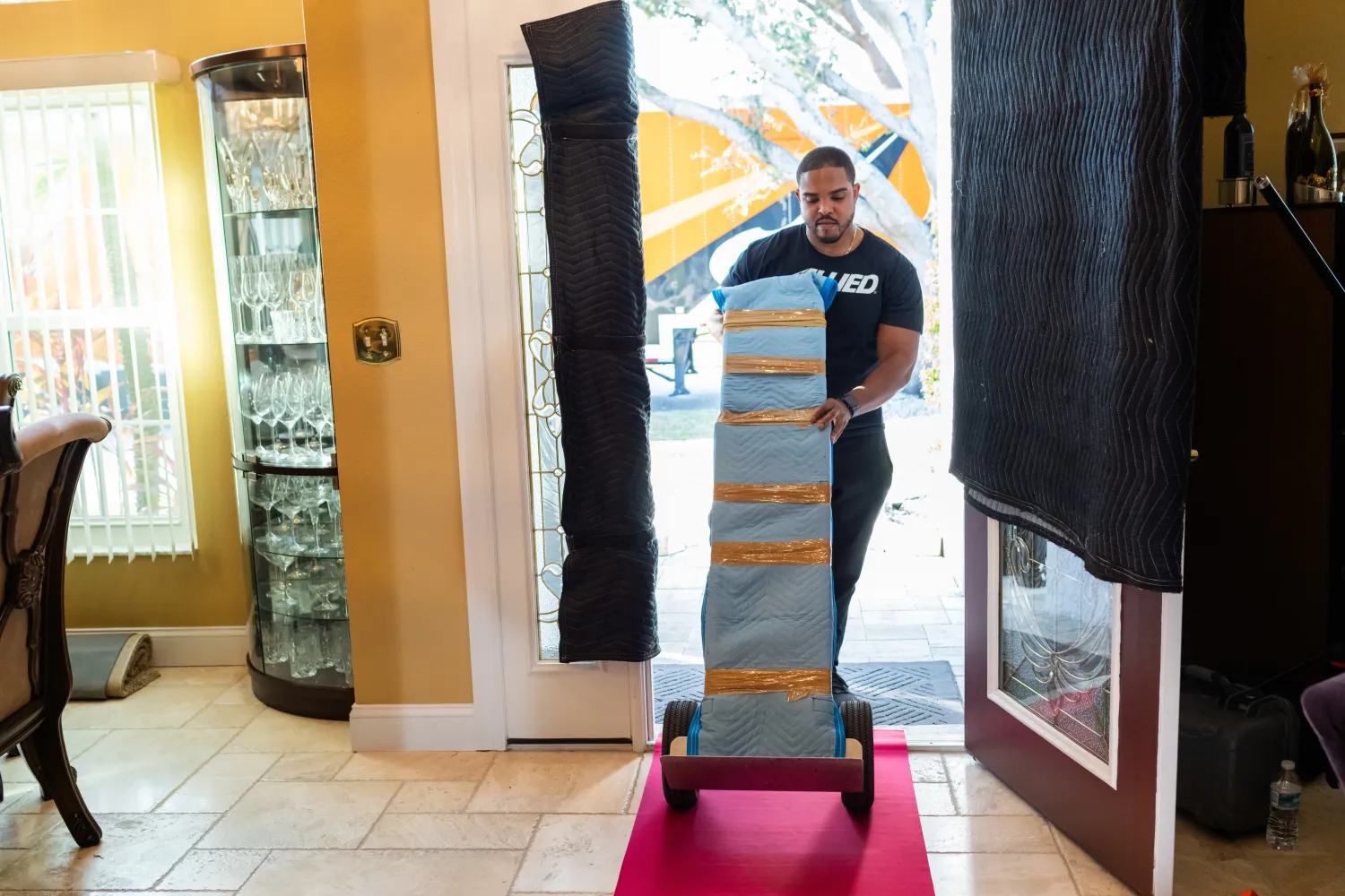 Allied mover bringing dolly cart into a house